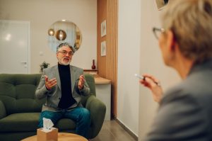 a-mature-man-in-crisis-is-discussing-trauma-with-a-psychotherapist.jpg